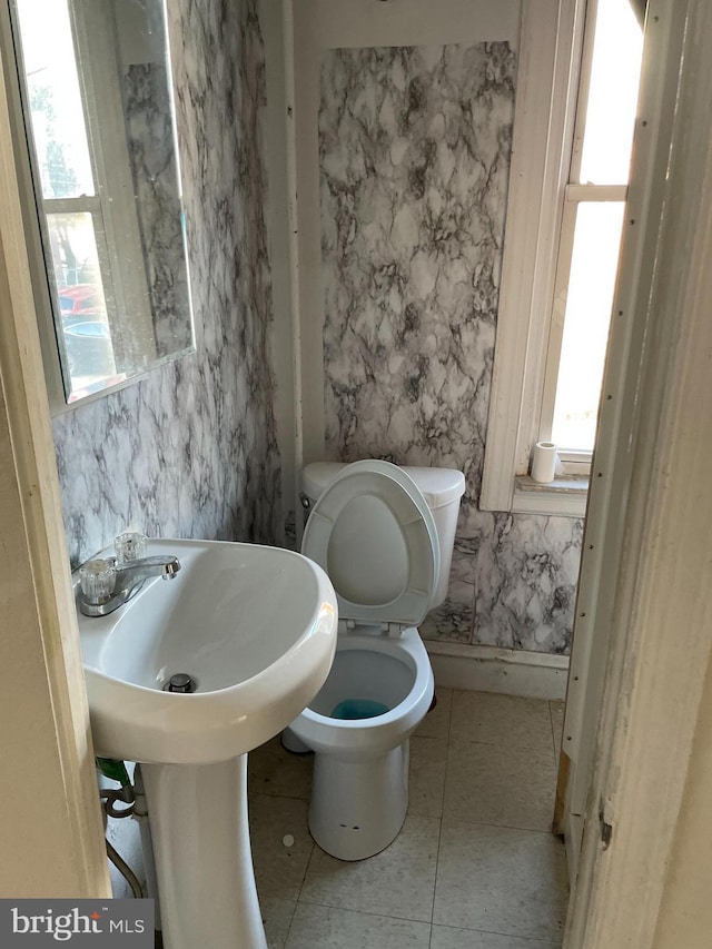 bathroom featuring toilet and tile patterned floors