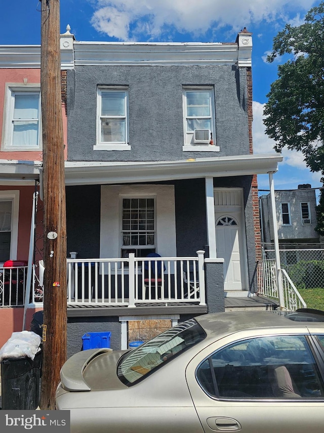 multi unit property featuring cooling unit and covered porch