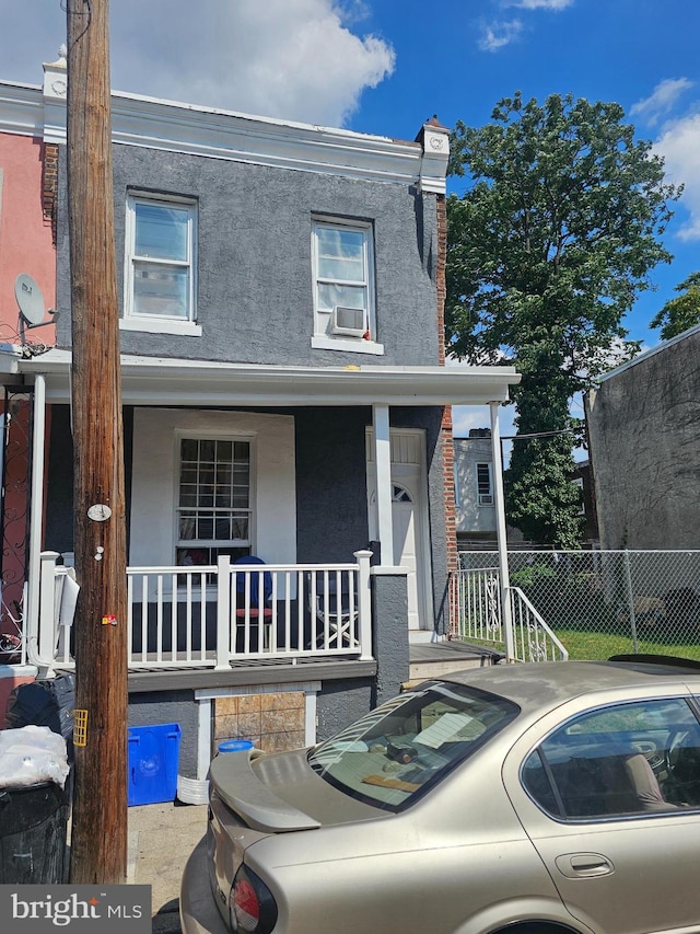 view of property with a porch and cooling unit