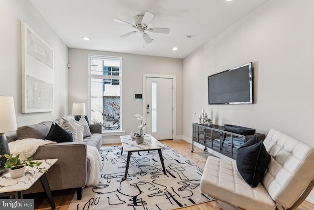 living room featuring ceiling fan and light wood-type flooring