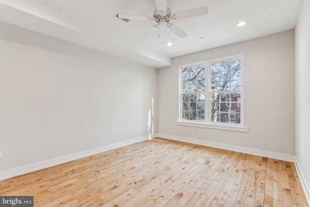 spare room featuring light wood-type flooring and ceiling fan