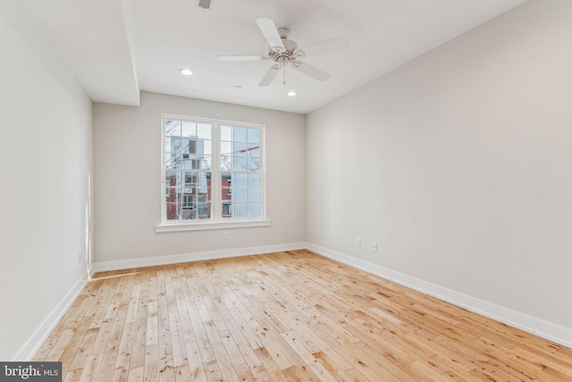 spare room featuring ceiling fan and light hardwood / wood-style flooring