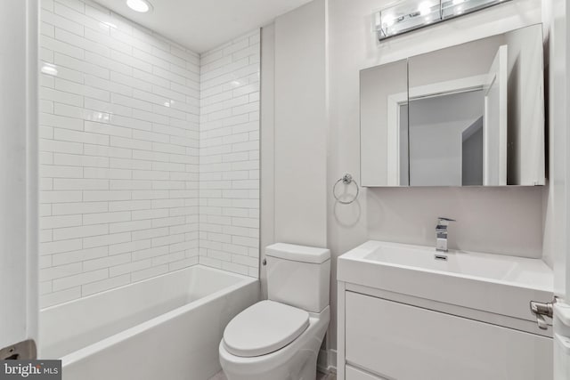 full bathroom with toilet, tiled shower / bath, and vanity