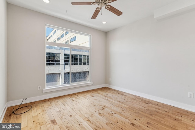 empty room featuring ceiling fan and light wood-type flooring