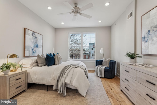 bedroom with ceiling fan and light hardwood / wood-style floors