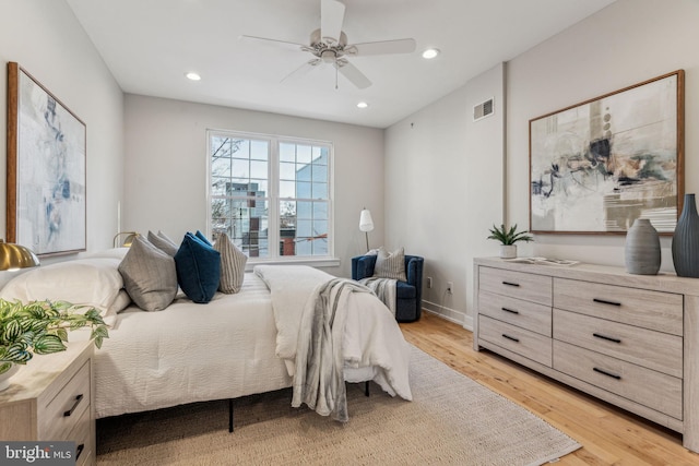 bedroom with ceiling fan and light hardwood / wood-style floors