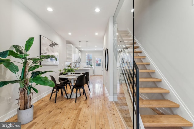 staircase with hardwood / wood-style flooring