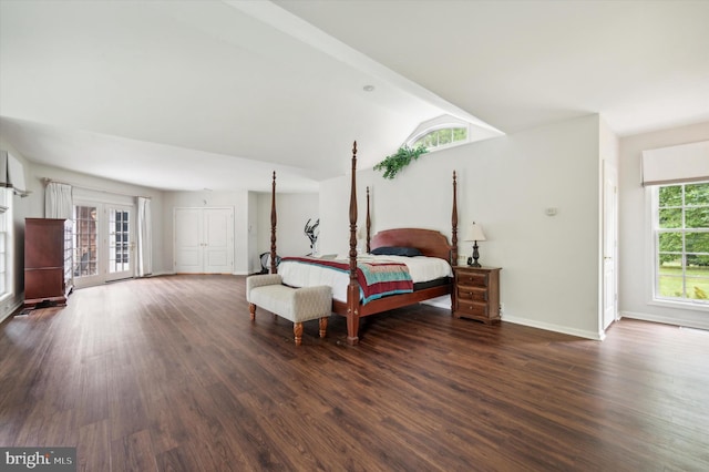 bedroom with french doors, lofted ceiling with beams, multiple windows, and dark wood-type flooring