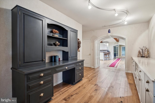 home office with light hardwood / wood-style floors