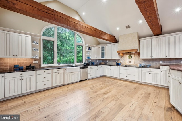 kitchen with lofted ceiling with beams, white cabinetry, light wood-type flooring, and custom range hood