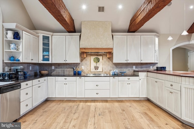 kitchen with custom exhaust hood, stainless steel appliances, beamed ceiling, light hardwood / wood-style floors, and white cabinetry