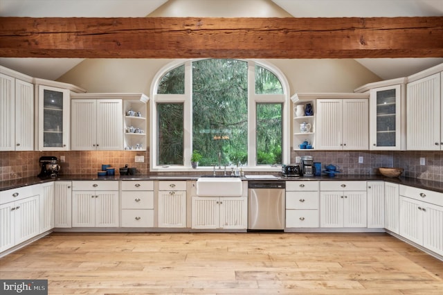 kitchen featuring stainless steel dishwasher, lofted ceiling with beams, white cabinetry, and sink