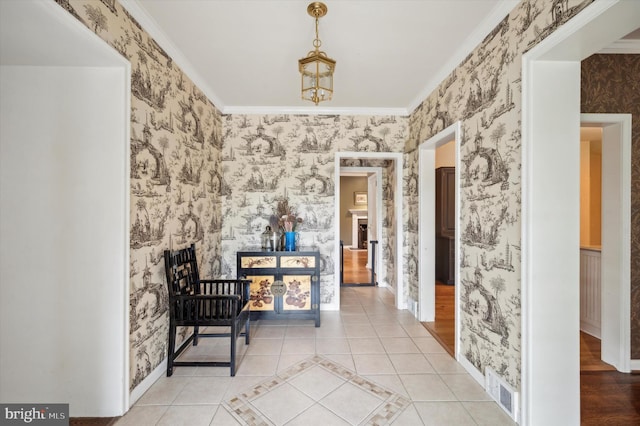 corridor with crown molding and light tile patterned flooring