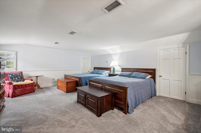 bedroom featuring light carpet and vaulted ceiling