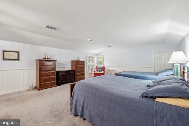 carpeted bedroom with vaulted ceiling