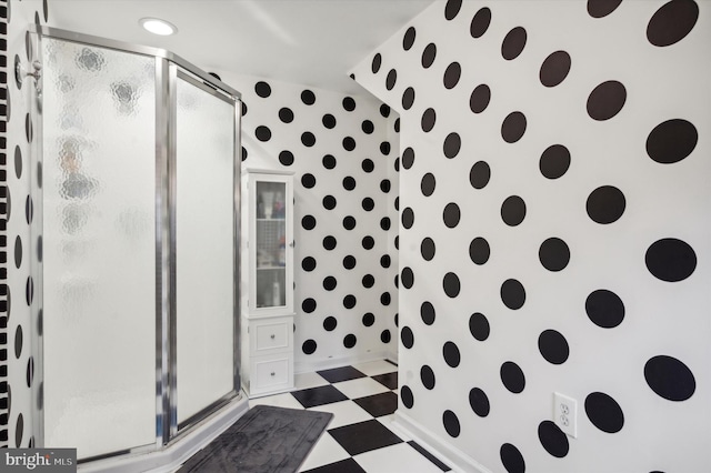 bathroom featuring a shower with shower door