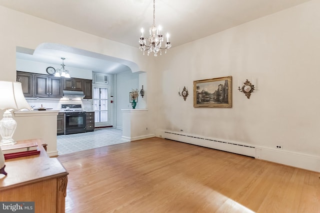 living room with an inviting chandelier, light wood-type flooring, and a baseboard heating unit