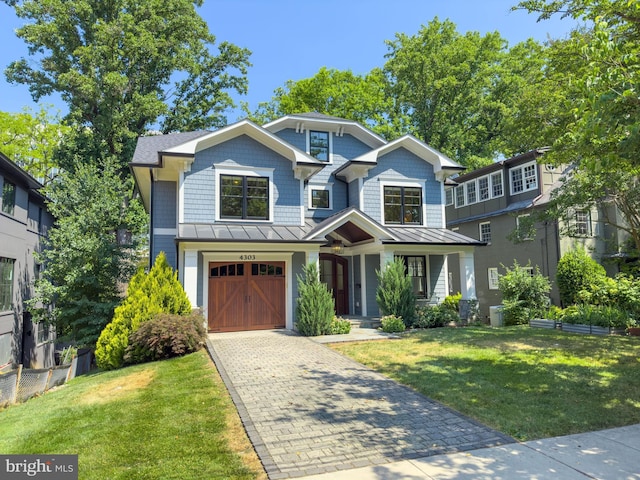 view of front facade with a front yard and a garage