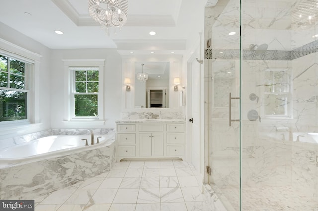 bathroom with plus walk in shower, an inviting chandelier, a tray ceiling, vanity, and ornamental molding