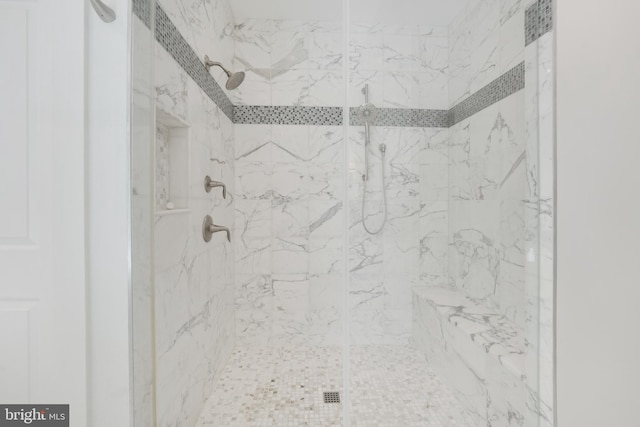 bathroom with a tile shower