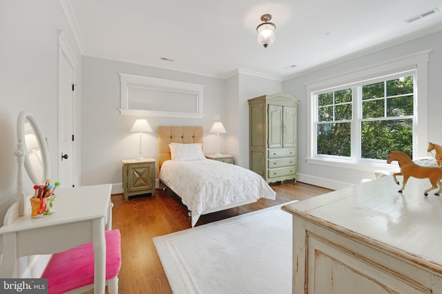 bedroom featuring crown molding and light wood-type flooring