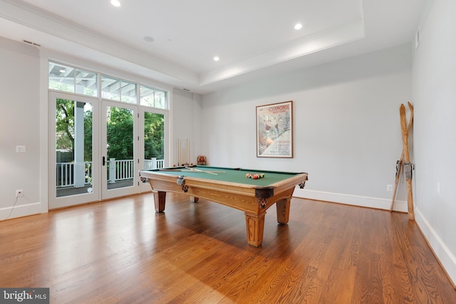 playroom featuring light wood-type flooring, a raised ceiling, and billiards