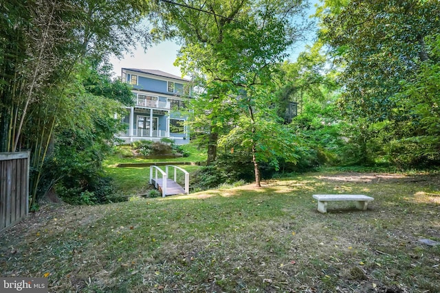 view of yard featuring a balcony