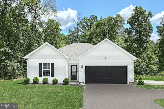 view of front facade featuring a garage and a front lawn