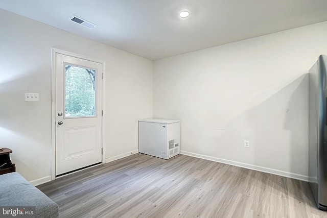 foyer entrance with light wood-type flooring