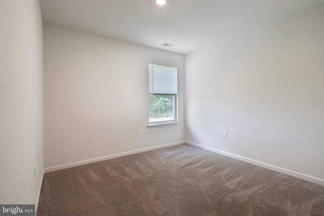 spare room featuring carpet