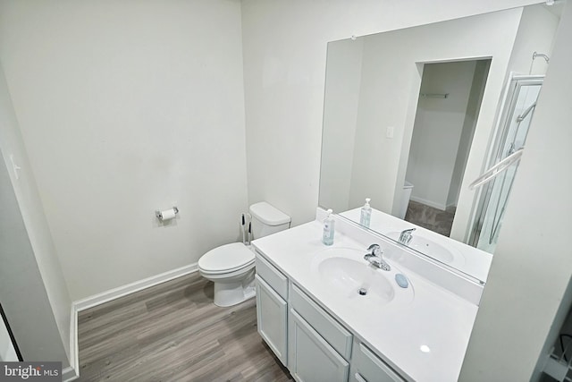 bathroom featuring hardwood / wood-style flooring, vanity, and toilet