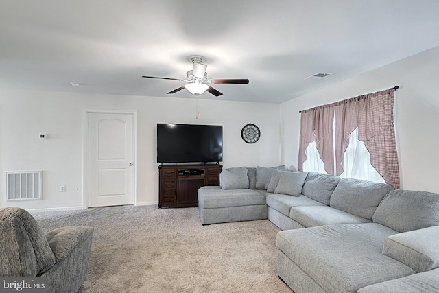 carpeted living room featuring ceiling fan