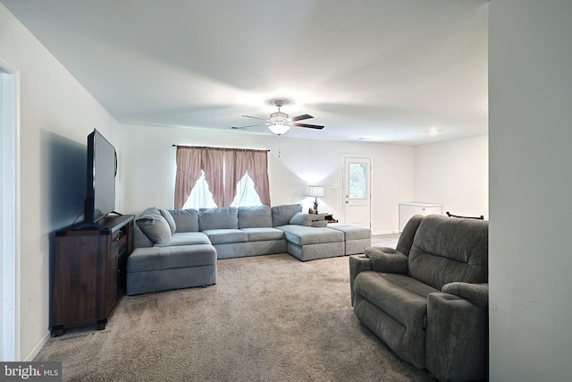 carpeted living room with ceiling fan