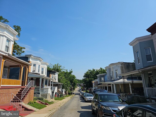 view of street featuring sidewalks, stairs, a residential view, and curbs