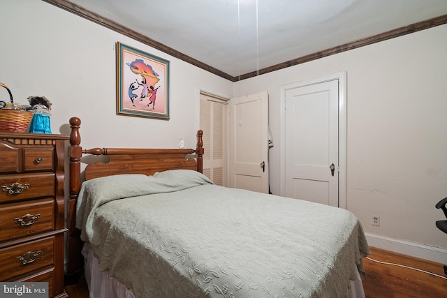 bedroom with ornamental molding and dark wood-type flooring