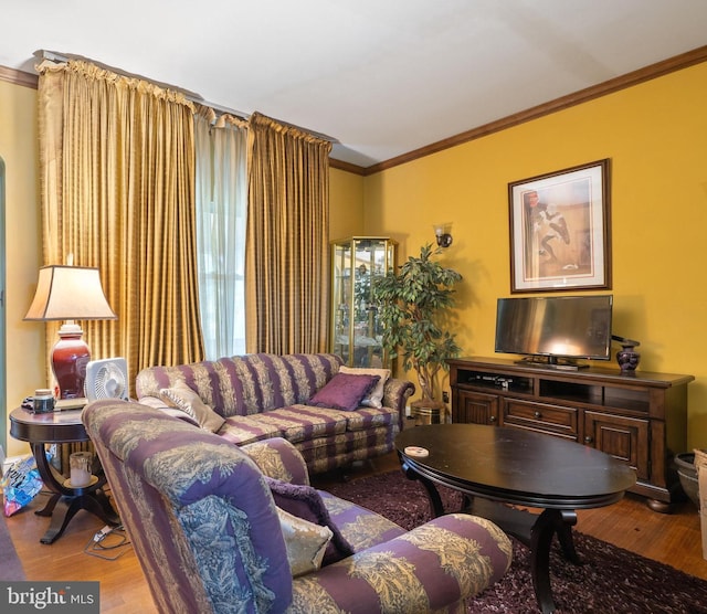 living room featuring hardwood / wood-style flooring and ornamental molding