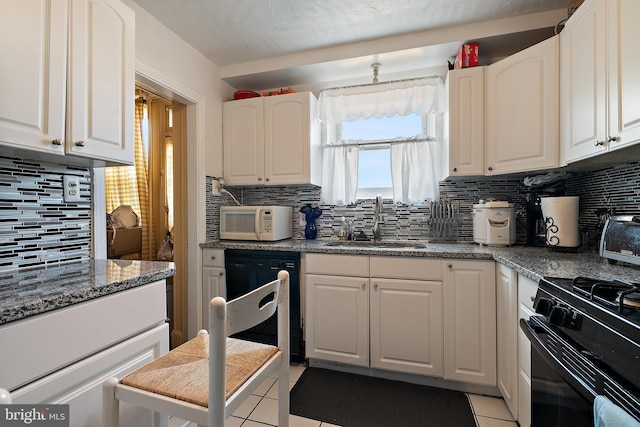 kitchen featuring stone counters, sink, white cabinets, and black appliances