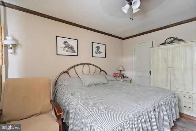 bedroom with ceiling fan and ornamental molding