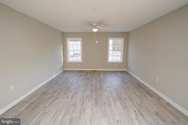 empty room featuring ceiling fan and light hardwood / wood-style floors