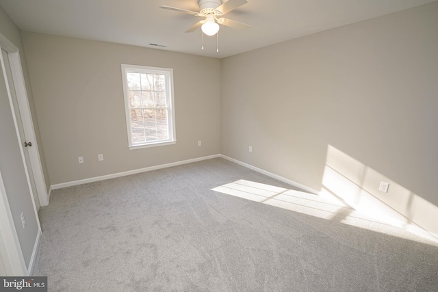 unfurnished room with ceiling fan and light colored carpet