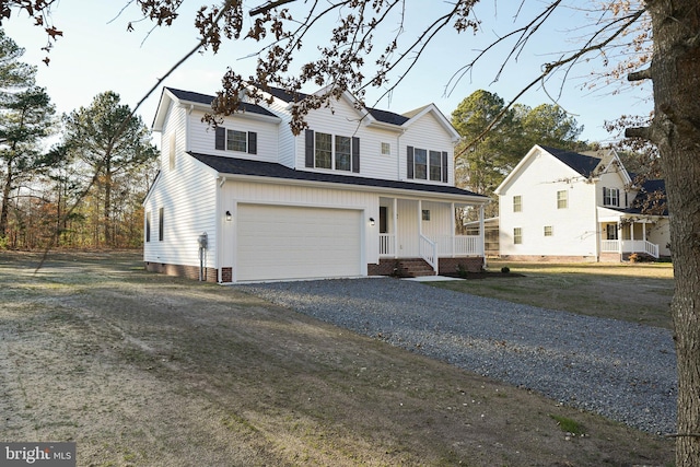 view of front facade featuring a porch, a garage, and a front lawn