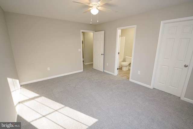 unfurnished bedroom featuring ensuite bathroom, ceiling fan, and light carpet