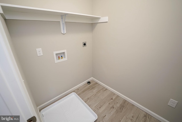 laundry area featuring washer hookup, light wood-type flooring, and hookup for an electric dryer