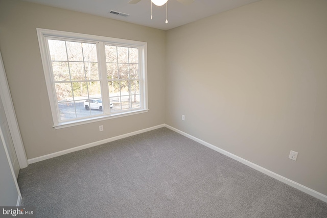 carpeted spare room featuring ceiling fan and a healthy amount of sunlight