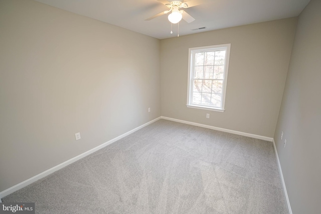 carpeted spare room with ceiling fan