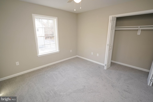 unfurnished bedroom featuring carpet flooring, a closet, and ceiling fan