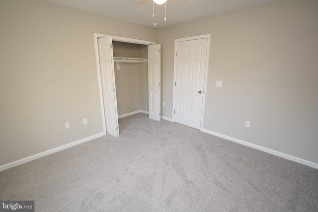 unfurnished bedroom featuring light carpet, a closet, and ceiling fan