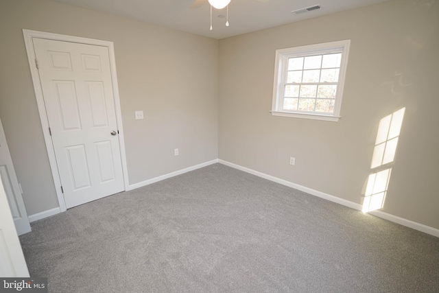 spare room featuring carpet floors and ceiling fan