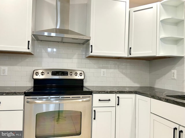 kitchen featuring white cabinetry, wall chimney range hood, decorative backsplash, and stainless steel electric range oven