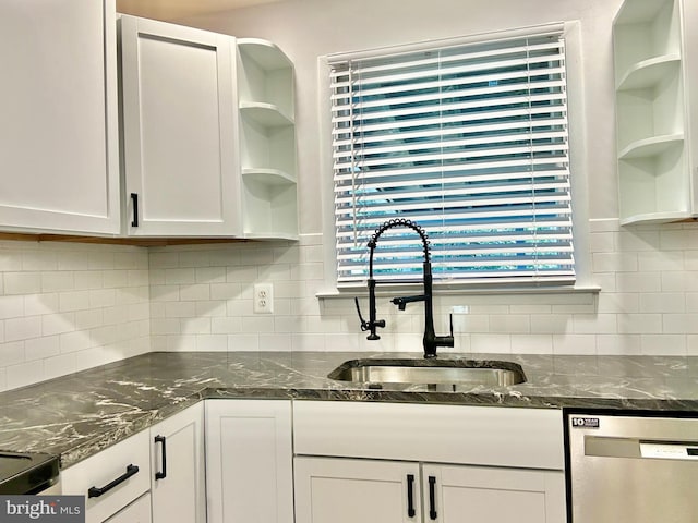 kitchen with white cabinetry, stainless steel dishwasher, sink, and tasteful backsplash